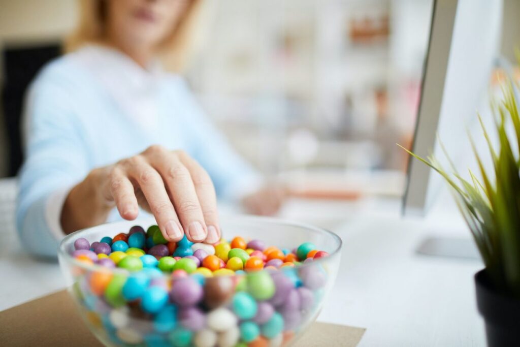Woman selecting candy to eat while working preventative dentistry dentist in Indianapolis Indiana